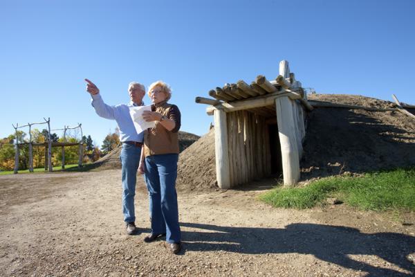 Couple in front of the earth lodges