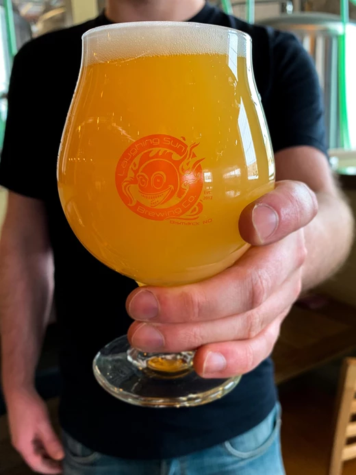 glass with the laughing sun logo
