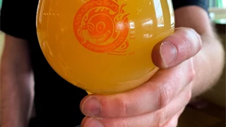 glass with the laughing sun logo